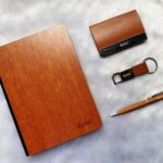 A corporate combo gift typically includes a selection of useful and practical items that can be used in a professional setting. The items you mentioned, a wooden diary, a card holder, a pen, and a keychain, are all common choices for corporate gifts.