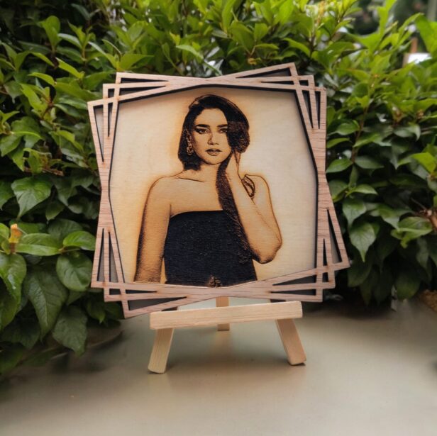 Custom 3D wood carved poster displayed in a personalized engraved wooden photo frame with a sturdy wooden stand, showcasing natural wood grain texture and unique design