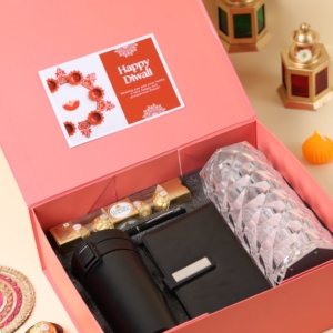 Diwali gift hamper including mini diary, insulated coffee mug, metal pen, Ferrero Rocher chocolates, crystal touch lamp, and personalized Diwali card.