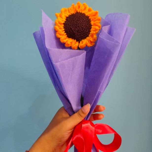 Handmade customizable single sunflower crochet bouquet wrapped in purple paper