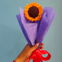 Handmade customizable single sunflower crochet bouquet wrapped in purple paper